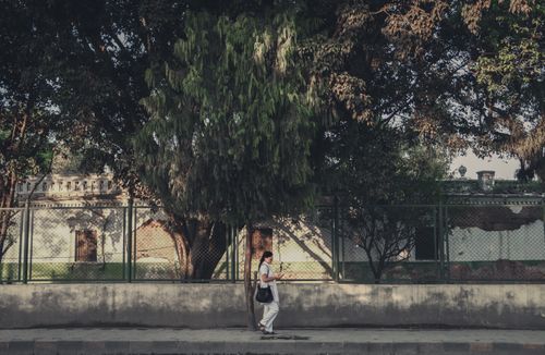 Nepali,girl,walking,by,the,side,of,old,building