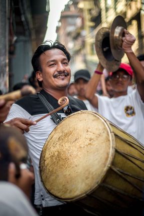 A,man,playing,local,drums,"Dhime",on,the,Kathmandu's,biggest,street,festival,of,Indra,Jatra.
