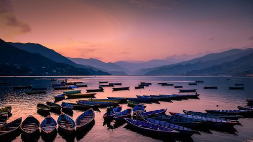Gloomy,Sunset,and,parking,colorfull,boats,at,Phewa,Lake,,Pokhara,,Nepal