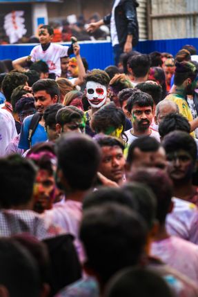 boy,standing,crowd,face,paint,occasion,holi,festival,colors