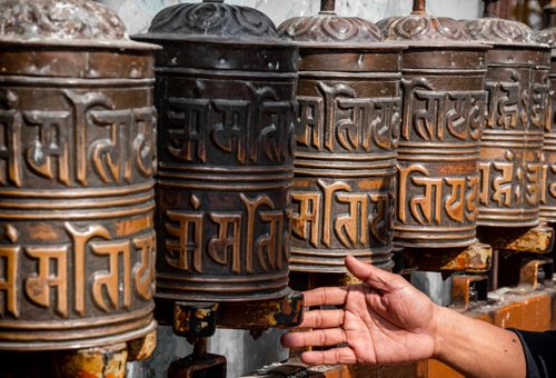 person,rotating,prayer,wheel,baudhanath,stupa