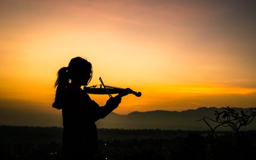 young,lady,enjoying,play,violin,sunrise,kathmandu,nepal