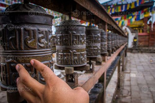 Find  the Image Walking,on,the,path,of,religion,,prayer,wheels and other Royalty Free Stock Images of Nepal in the Neptos collection.