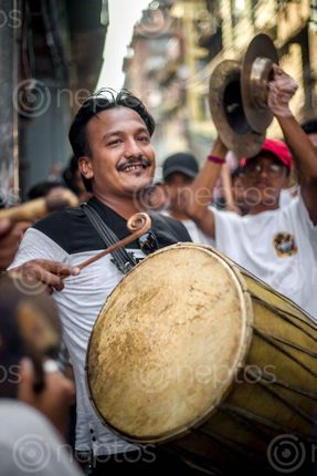 Find  the Image A,man,playing,local,drums,"Dhime",on,the,Kathmandu's,biggest,street,festival,of,Indra,Jatra. and other Royalty Free Stock Images of Nepal in the Neptos collection.