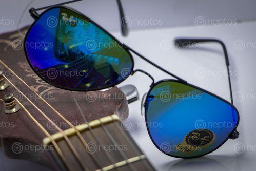 Find  the Image Blue, ray ban, sunglasses, guitar  and other Royalty Free Stock Images of Nepal in the Neptos collection.