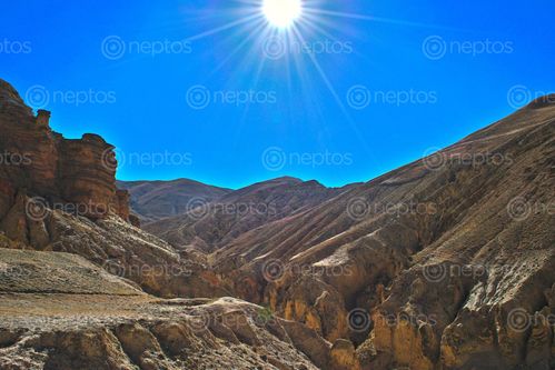 Find  the Image view,sun,shining,hills,opposite,chosar,cave  and other Royalty Free Stock Images of Nepal in the Neptos collection.