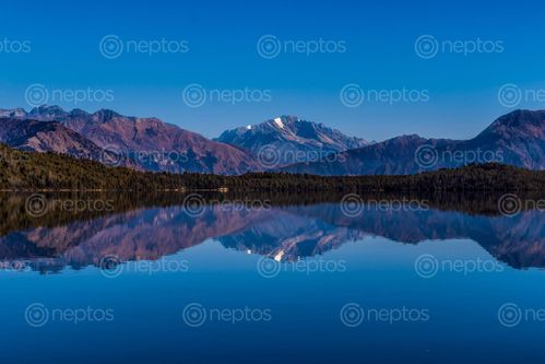 Find  the Image beautiful,reflection,mountain,rara,lake  and other Royalty Free Stock Images of Nepal in the Neptos collection.