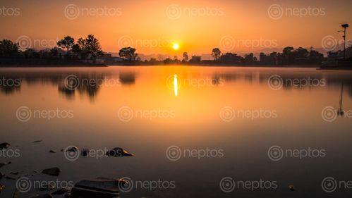 Find  the Image sunrise,photo,taudah,lake,kathamndu,nepal  and other Royalty Free Stock Images of Nepal in the Neptos collection.
