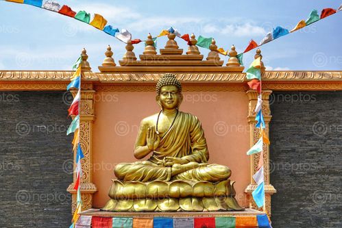 Find  the Image golden,buddha,statue,colourful,prayer,flags,chaudhary,grup,cg,temple,located,dumkauli,devchli,municipality,nawalparasi,distric,nepal  and other Royalty Free Stock Images of Nepal in the Neptos collection.