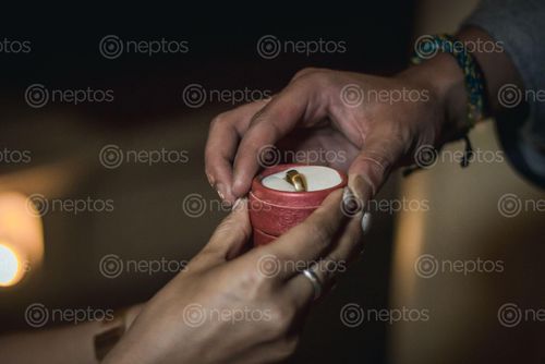 Find  the Image close,young,women,hands,passing,wedding,ring  and other Royalty Free Stock Images of Nepal in the Neptos collection.