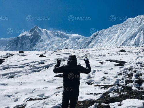 Find  the Image man,posing,front,himalayas,tilicho,lake  and other Royalty Free Stock Images of Nepal in the Neptos collection.