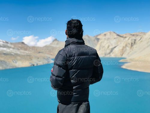 Find  the Image man,black,jacket,enjoying,beautiful,view,tilicho,lake  and other Royalty Free Stock Images of Nepal in the Neptos collection.