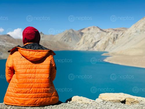 Find  the Image man,yellow,jacket,enjoying,beautiful,view,tilicho,lake  and other Royalty Free Stock Images of Nepal in the Neptos collection.
