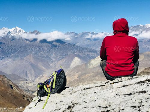 Find  the Image man,trekking,bag,resting,enjoying,surreal,view,mustang,thorang,la,trial  and other Royalty Free Stock Images of Nepal in the Neptos collection.