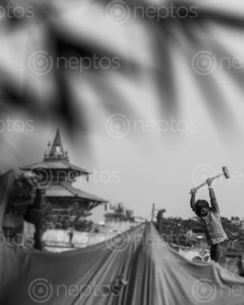 Find  the Image photo,basantapurkathmandu,reconstruction,kathmandu,durbar,square,world,heritage,site,background,temple,squarethe,man,foreground,working,mid,sunny,day,earn,living,good,perfect,shot,time  and other Royalty Free Stock Images of Nepal in the Neptos collection.