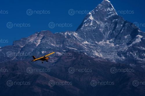 Find  the Image ultralight,flying,mount,fishtail,pokhara,nepal  and other Royalty Free Stock Images of Nepal in the Neptos collection.