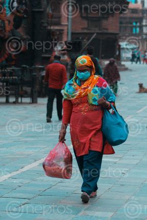 Find  the Image woman,covered,mask,shawl,walks,past,streets,hanumandhoka,struggle,real,lockdown,day-14  and other Royalty Free Stock Images of Nepal in the Neptos collection.