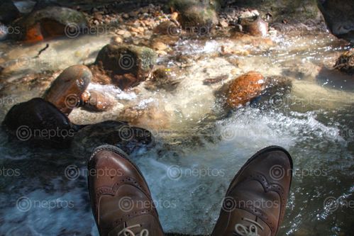 Find  the Image shot,represents,dirty,shoes,traveller,resting,river  and other Royalty Free Stock Images of Nepal in the Neptos collection.