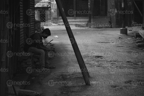 Find  the Image man,sitting,streets,kathmandu,time,lockdown  and other Royalty Free Stock Images of Nepal in the Neptos collection.