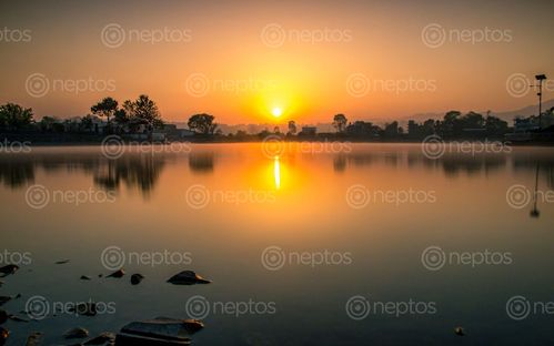 Find  the Image beautiful,sunrise,taudah,lake,kathmandu,nepal  and other Royalty Free Stock Images of Nepal in the Neptos collection.