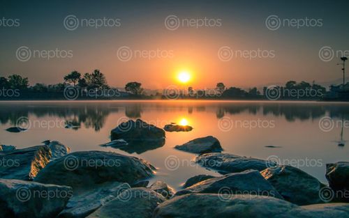 Find  the Image beautiful,sunrise,taudah,lake,kathmandu,nepal  and other Royalty Free Stock Images of Nepal in the Neptos collection.