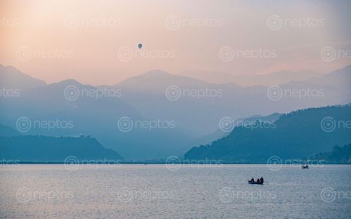 Find  the Image gloomy,sunset,flying,hot,air,balloon,fewa,lake,pokhara,nepal  and other Royalty Free Stock Images of Nepal in the Neptos collection.