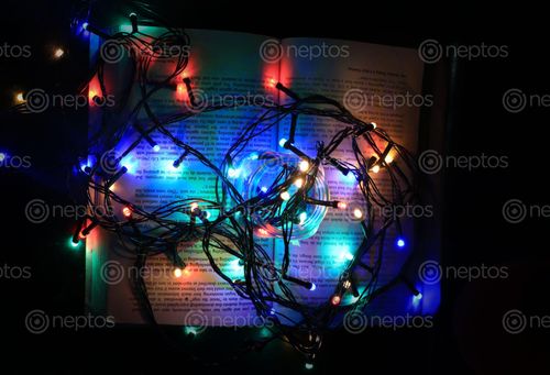 Find  the Image christmas,lights,glass,bottle,book,black,background  and other Royalty Free Stock Images of Nepal in the Neptos collection.