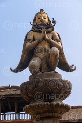 Find  the Image garuda,statue,hand,gesture,namaste,greeting,patan,durbar,square,nepal  and other Royalty Free Stock Images of Nepal in the Neptos collection.