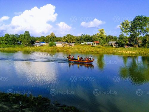 Find  the Image people,enjoying,boat,ride,village  and other Royalty Free Stock Images of Nepal in the Neptos collection.