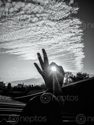 Find  the Image picture,sunrays,coming,hole,made,crossing,fingers  and other Royalty Free Stock Images of Nepal in the Neptos collection.