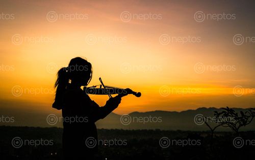 Find  the Image young,lady,enjoying,play,violin,sunrise,kathmandu,nepal  and other Royalty Free Stock Images of Nepal in the Neptos collection.