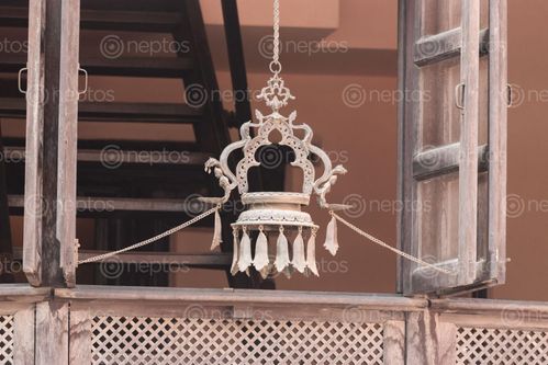 Find  the Image hanging,panashanging,oil,lamp,hanged,window,decorate,house,means,praying,god,nepal  and other Royalty Free Stock Images of Nepal in the Neptos collection.