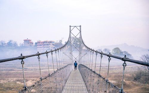 Find  the Image morning,view,sikali,suspension,bridge,lalitpur,nepal  and other Royalty Free Stock Images of Nepal in the Neptos collection.