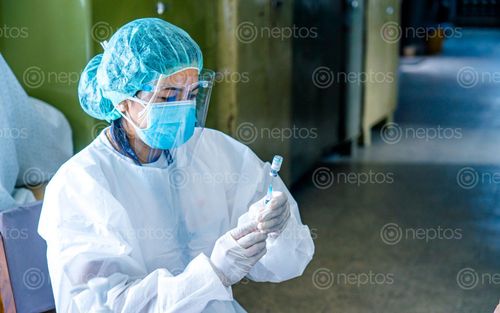 Find  the Image nurse,giving,covid-19,vaccine,patient,vaccination,prevention,corona,virus,pandemic  and other Royalty Free Stock Images of Nepal in the Neptos collection.